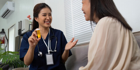 Patient Care and Medication Discussion. A nurse joyfully explains medication instructions to an...