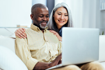 cinematic image of an happy multiethnic senior couple. Indoors Lifestyle moments at home. Concept...