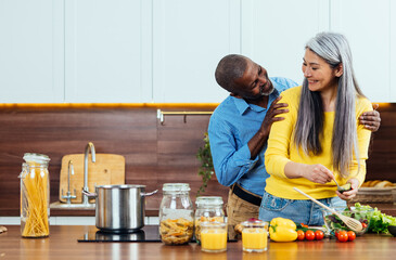 cinematic image of an happy multiethnic senior couple. Indoors Lifestyle moments at home. Concept...
