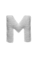 Handmade crocheted letter M in light grey yarn, isolated on white back