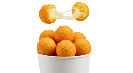A close up of a bucket of cheese balls with one broken open showing the cheese inside it all on black