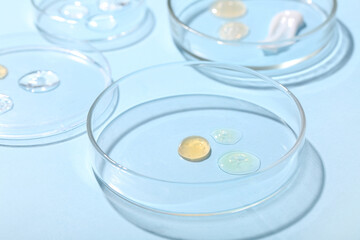 Petri dishes with samples on blue background