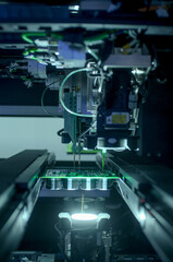 Circuit board moving through assembly line. Electronics component installation, CMD. Automated