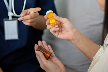 Caregiver and Elderly Support. A caregiver discussing medication with an elderly patient, ensuring proper understanding and compliance.