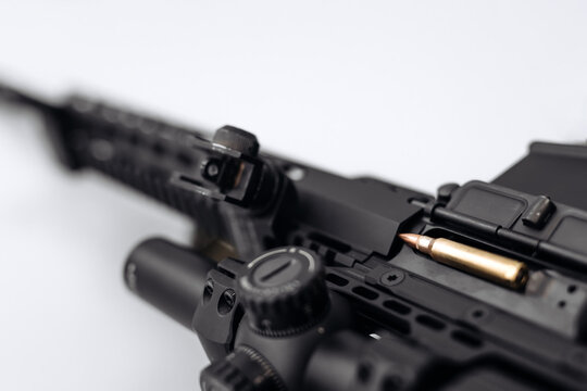 A close-up of a machine gun on a white background. The concept of selling or buying a gun.