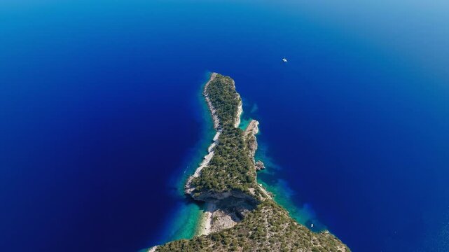 Aerial top down of deep blue waters around Hulla Beach, Ithaca Island
