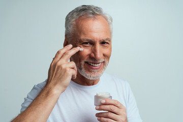 Handsome senior  isolated on grey background. Concept about the third age and seniority