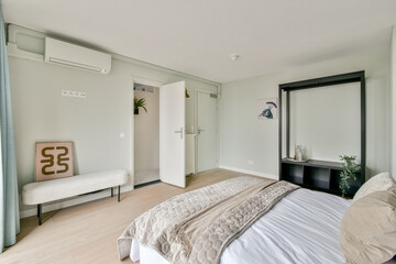 A modern bedroom showcasing minimalistic design elements with soft colors and stylish furniture, creating a serene and inviting atmosphere.