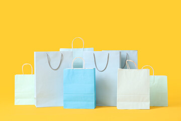 Shopping bags on yellow background