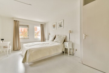 A serene and elegantly designed bedroom featuring soft neutral colors, natural light, and minimalistic decor, perfect for relaxation and comfort.