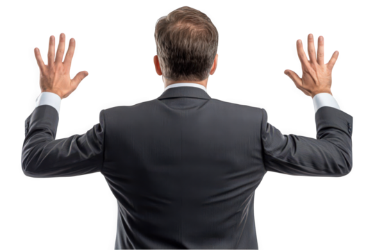 Confident Caucasian businessman in a suit with arms raised against a white background.