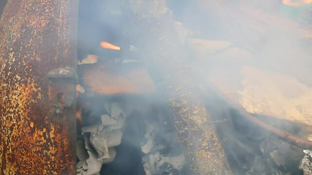 burning wood and paper. firewood is burning. tongues of flame. orange flame. bonfire. wood-fired cooking. firewood is burning for cooking barbecue