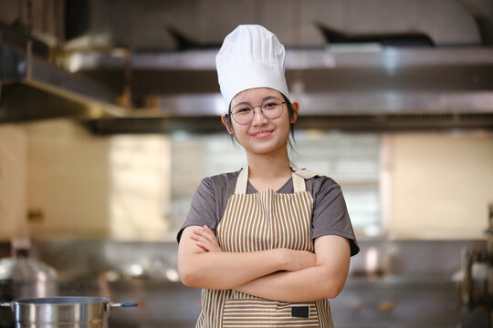Portrait young teen girl cook student. Cooking class. Culinary classroom. Happy young woman students for cooking in cooking school.