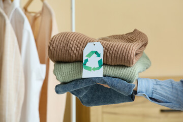 Woman with natural clothes for recycling indoors