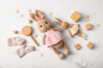 Composition with toys and baby socks on light background