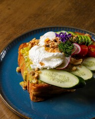Indulging in vibrant avocado toast with poached eggs and fresh veggies cozy kitchen setting close-up food photography perfect for food lovers