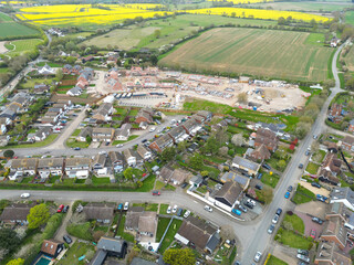 Aerial view of a large, sprawling housing development in East Anglia, UK. The older part of the...