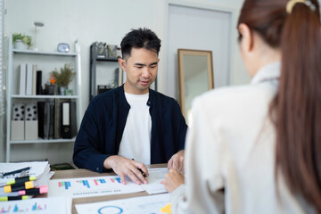 Collaboration and Professional Development. A young professional reviewing data insights with a colleague.
