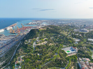 Aerial view of Montjuic hill and Barcelona's industrial port in the background