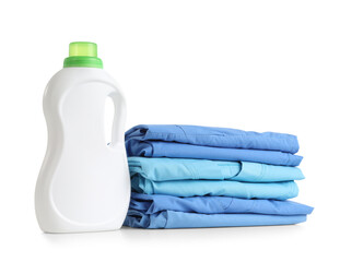 Stack of clean clothes and laundry detergent bottle isolated on white background