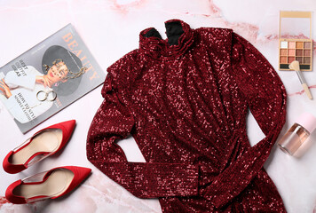 Composition with stylish female dress, accessories, cosmetics and magazine on light background