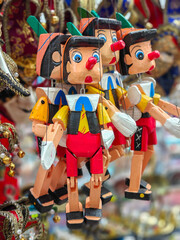Many wooden puppets of Pinocchio are on display at the street market in Venice