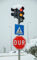 stop sign in the snow. Traffic light under the snowfall