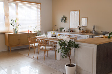 Interior of kitchen decorated for Easter with dining table and counters
