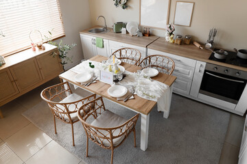 Interior of kitchen decorated for Easter with dining table and counters