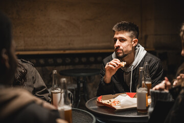 Group of friends enjoying late-night snacks and conversation in a cozy eatery