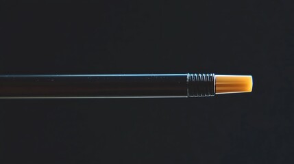 Close-up of a sleek black marker with a bright yellow tip, against a simple dark background