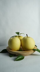pears on a wooden tray white background