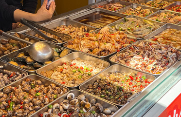 A vibrant and enticing display of an array of various seafood delicacies in a lively and bustling market setting