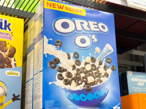 Oreo O's cereal box with milk splashes and chocolate pieces, showcasing a delightful breakfast experience concept