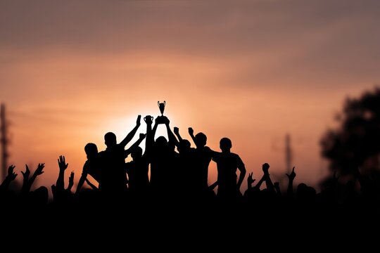 Silhouettes of cheering crowd with trophy