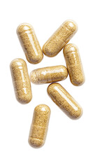 Close-up of several clear capsules filled with light brown granules on trasparent background