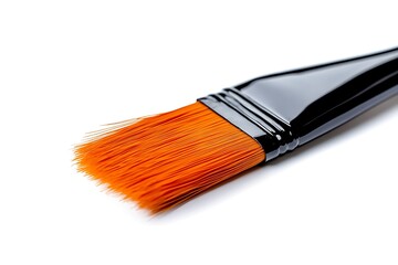 Fototapeta premium A paintbrush with orange bristles and a black handle, isolated on a white background