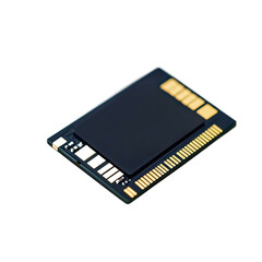 A close-up view of a dark rectangular electronic circuit board with intricate gold connections.