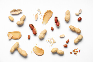 Composition with peanuts and smears of butter on light background