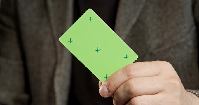 Man in the jacket holds a credit card template, which is ideal for creating layouts, digital payments, and finance-related projects. Without a corporate identity, it is perfect for creating customizab