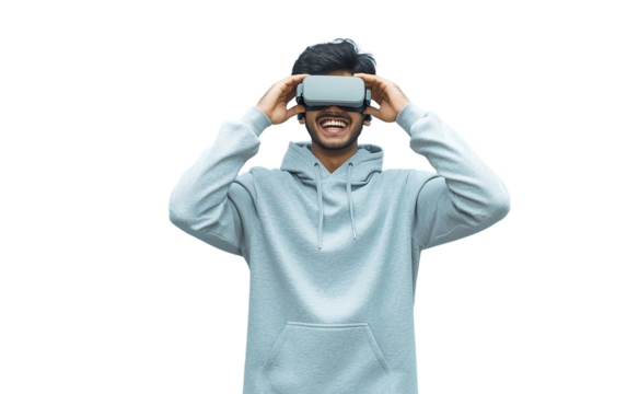Excited Indian young man in gray hoodie holding VR headset near his eyes, isolated on pastel background, perfect for tech, virtual reality, or playful moments.

 - Powered by Adobe