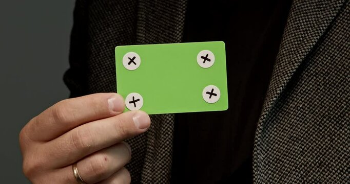 Man in the jacket holds a credit card template, which is ideal for creating layouts, digital payments, and finance-related projects. Without a corporate identity, it is perfect for creating customizab