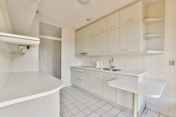 A spacious and sleek modern kitchen featuring white cabinetry, minimalist design, and clean lines, beautifully arranged for functionality and style.