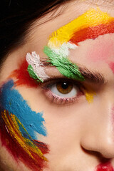 Vibrant face art enhances stunning young womans beauty in creative expression