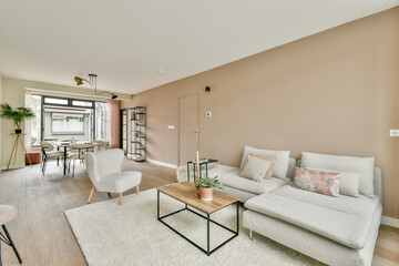 A stylish modern living room featuring a cozy seating area, sleek furniture, and neutral color tones, creating a warm and inviting atmosphere for relaxation.