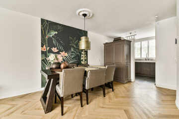A stylish dining area featuring a striking botanical mural, elegant furniture, and warm wooden flooring, creating a contemporary and inviting atmosphere.