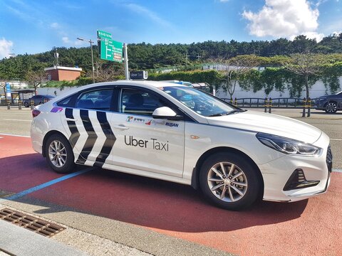 Busan, South Korea on 8 Nov 2025. Uber Taxi Car Waiting on the Roadside on a Sunny Day
