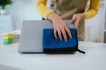 Professional cleaner wearing gloves performs household chores with cleaning equipment, ensuring...