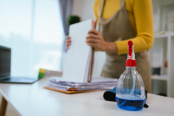 Professional cleaner wearing gloves performs household chores with cleaning equipment, ensuring...