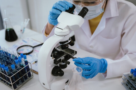 Scientist analyzes biological samples using advanced laboratory equipment for medical research, diagnosis, biotechnology development, and pharmaceutical or clinical discoveries.